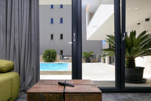 a living room with a view of a swimming pool at Villa Kajgo-Pag in Pag