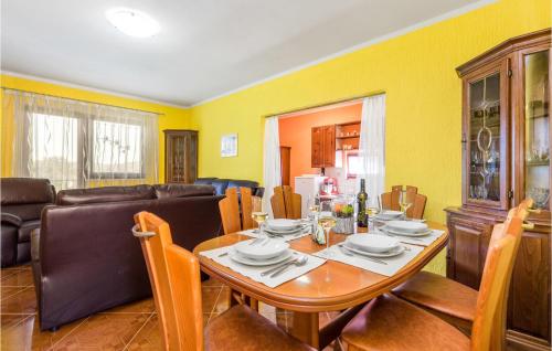 a dining room with a table and a couch at Amazing Home In Bosiljevo With Kitchen in Bosiljevo