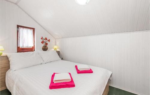 a white bed with two red trays on it at Amazing Home In Bosiljevo With Kitchen in Bosiljevo