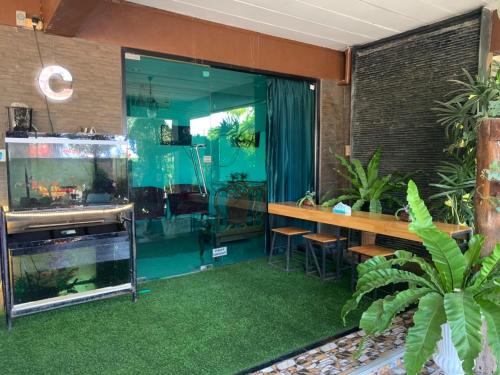 a living room with a fish tank and a counter at Lert Sri Hotel in U Thong