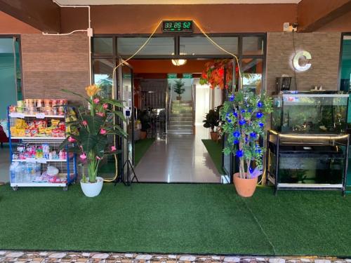 an entrance to a store with flowers and plants at Lert Sri Hotel in U Thong