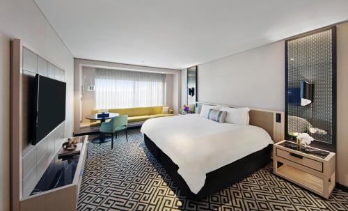 a hotel room with a large bed and a television at The Star Grand Hotel and Residences Sydney in Sydney