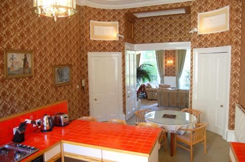 a kitchen with a red counter top and a table at Regent Terrace, Central and Charming, Quiet in Edinburgh