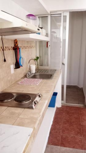 a kitchen with a sink and a counter top at La Vivienda Villa in Santa Cruz Huatulco