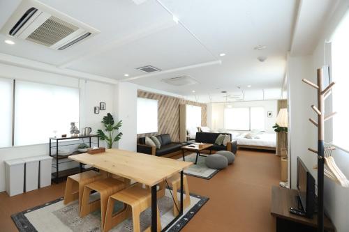 a living room with a table and a couch at RIVER SUITES HIROSHIMA in Hiroshima