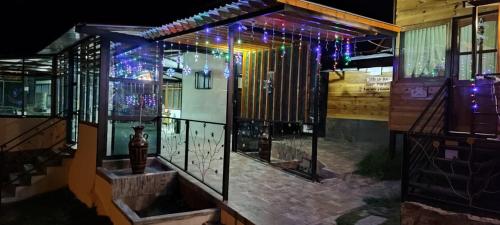 a house with christmas lights on the front of it at El Rincón de Gabo in Nobsa