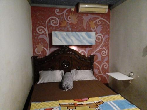 Postel nebo postele na pokoji v ubytování Hotel Alifah 1 Syariah