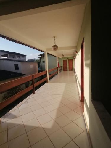an empty corridor of a building with a balcony at Aquarela Suítes in Piúma