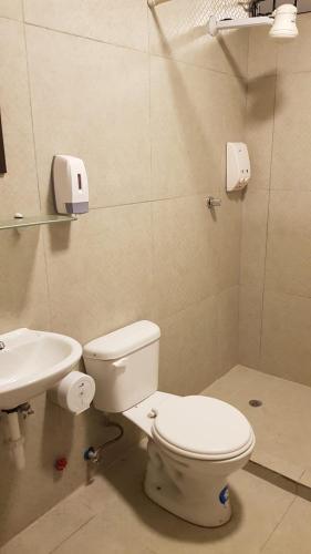 a bathroom with a toilet and a sink at Villa del Mar Departamento 1 I in Salinas