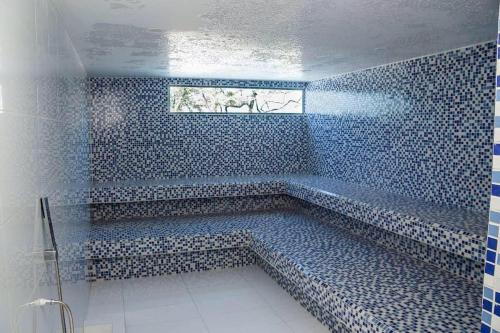 a blue tiled bathroom with a large tub in it at Apartamento en Samaria Club de Playa Privada Salida Directa al Mar en Pozos Colorados cerca a Zazue, Estelar, Playa Bello Horizonte, Cabo Tortuga #1 in Santa Marta