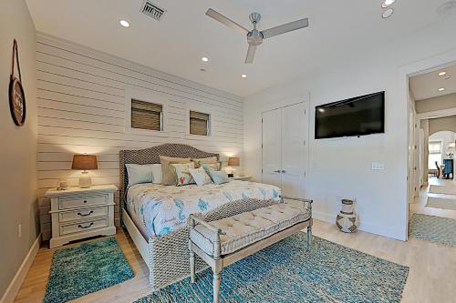 a bedroom with a bed and a tv on a wall at Palmilla Beach Resort in Port Aransas
