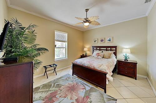 a bedroom with a bed and a ceiling fan at The Waves #A1 in South Padre Island