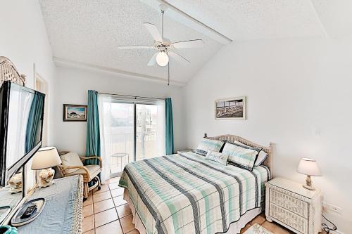 a bedroom with a bed and a ceiling fan at Dolphin Condominiums #12 in South Padre Island