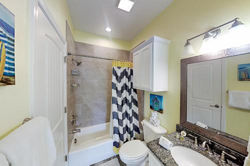 a bathroom with a toilet sink and a shower at Flip Flop and Relax in Port Aransas