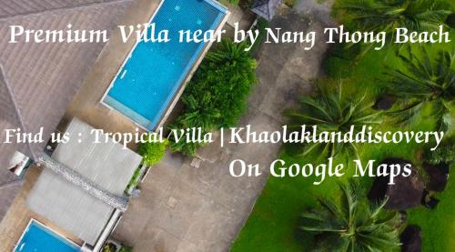 an overhead view of a swimming pool with palm trees at The Phura Villa Khaolak - SHA Extra Plus in Khao Lak