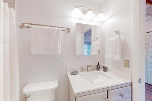 a white bathroom with a sink and a toilet at Chatuge Bell in Hiawassee