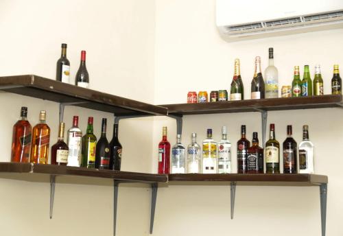a row of shelves filled with bottles of alcohol at HOTEL MALLIKA COMPANY, SL in Freetown