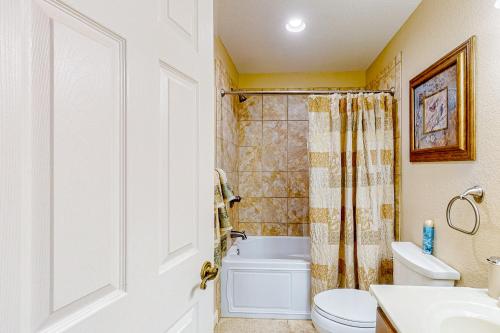 a bathroom with a toilet and a sink and a shower at Hillcrest Hideaway in Hiawassee