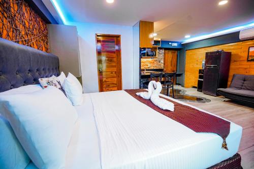 a bedroom with a bed with a stuffed animal on it at CLOCKWORKORANGE Luxury Suites 4-Minutes Away To Airport in Mactan