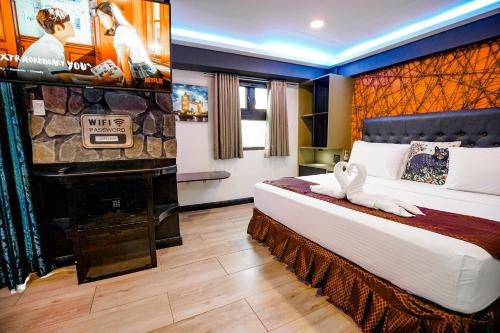 a hotel room with a bed and a piano at CLOCKWORKORANGE Luxury Suites 4-Minutes Away To Airport in Mactan