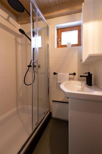 a bathroom with a shower and a sink at House Forest with HOT TUB in Otočac