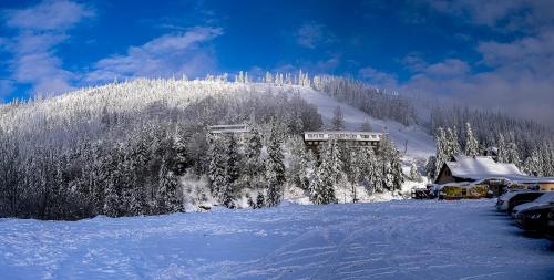 a snow covered mountain with a building on it at Stará Zvonica in Nižná Boca