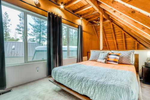 a bedroom with a bed in a room with windows at 18 Antelope in Sunriver