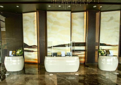 a bathroom with two sinks and a bath tub at Grand Summit Hotel General Santos in General Santos