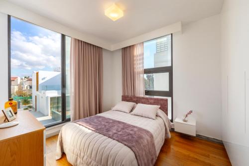a bedroom with a bed and a large window at Villa Laurus 6, walking distance to the beach in Paphos