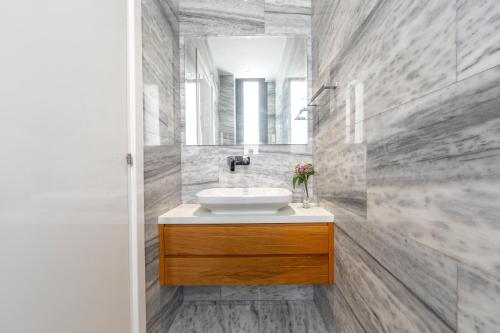 a bathroom with a sink and a mirror at Villa Laurus 6, walking distance to the beach in Paphos