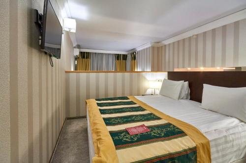 a bedroom with a large bed in a room at Pioneer Luxe Hotel in Saratov