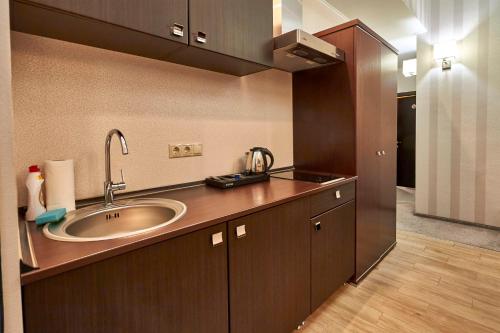 a bathroom with a sink and a counter top at Pioneer Luxe Hotel in Saratov