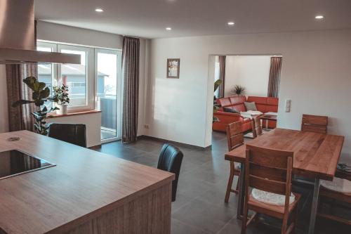 a kitchen and living room with a table and chairs at Ferienwohnung inmitten der Natur mit Sauna in Steinau an der Straße