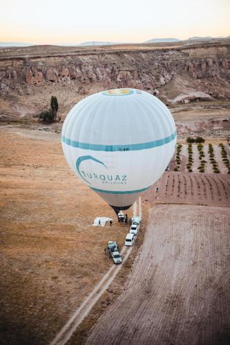 a hot air balloon in the middle of a field at Cappadocia Naif Hotel - Adults Only in Goreme