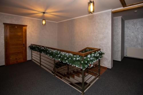 a room with a staircase with a christmasreath on it at Князів Двір in Bukovel
