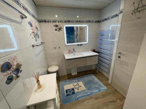 a bathroom with a sink and a mirror and a shower at Hälmli in Heiden