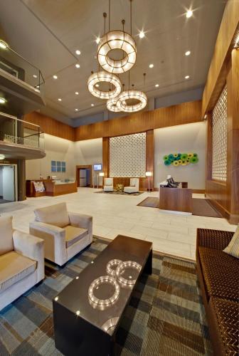 a lobby with couches and a chandelier at Coast Kamloops Hotel & Conference Centre in Kamloops