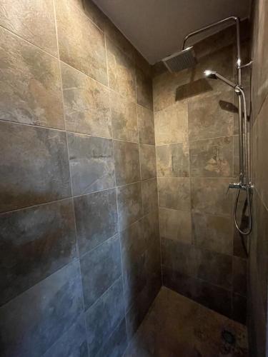a bathroom with a shower with a tiled wall at Villa Vista Calpe in Calpe