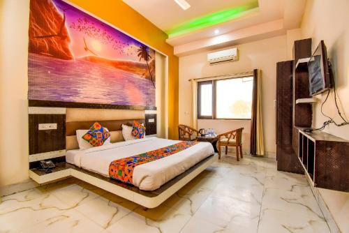 Habitación de hotel con cama y TV en FabHotel Prime Sumanglam, en Dehradun