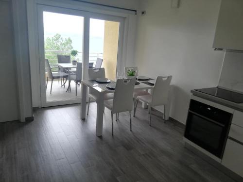 a kitchen and dining room with a table and chairs at Novi Lux in Novi Vinodolski