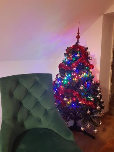 a christmas tree in a living room with a couch at Pokoje u Jana in Kazimierz Dolny