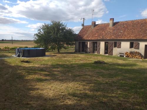 an old house with a yard next to a building at La fadette in Argy