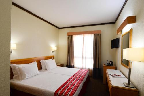 Postel nebo postele na pokoji v ubytování Hotel Dom Nuno