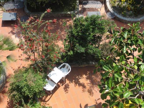 an overhead view of a garden with a white bench at Residence Dei Fiori in Pietra Ligure