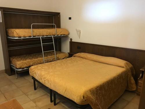 two beds in a room with two bedsskirts at Agriturismo Aqua Viva in Acquaviva Picena