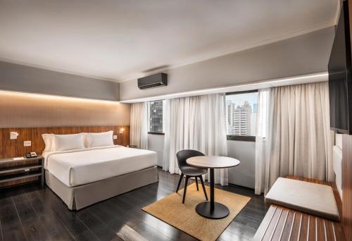 a hotel room with a bed and a table at INNSiDE by Meliá São Paulo Iguatemi in São Paulo