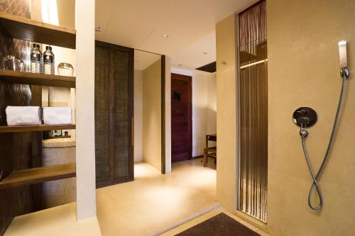 a bathroom with a shower in a room at Hansar Samui Resort & Spa - SHA Extra Plus in Bophut