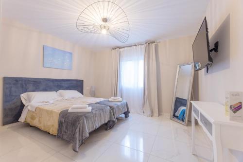 a bedroom with a bed and a large window at Residencia Deportiva RozaRossa in Estepona