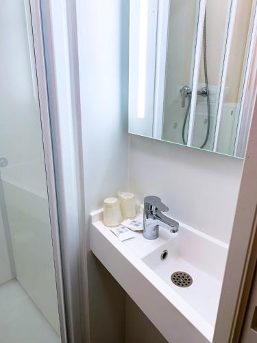 a bathroom with a sink and a mirror at Premiere Classe Thionville - Yutz in Basse-Yutz