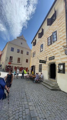 a group of people sitting outside of a building at Pension Linden in Český Krumlov